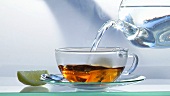 Making black tea: pouring hot water onto tea bag