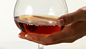 Pouring a glass of cognac