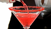 Pouring a glass of Cosmopolitan