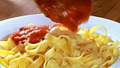 Serving ribbon pasta with tomato sauce
