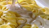 Serving ribbon pasta with Alfredo sauce