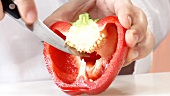 Halving and deseeding a red pepper