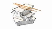 Three aluminium take-away food containers and chopsticks
