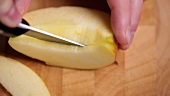 Cutting apple quarters into thin slices