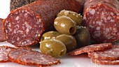 Various types of salami and green olives