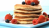 A stack of pancakes with fresh berries