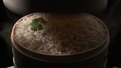 Steamed rice in a bamboo basket