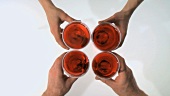 Toasting with four glasses of red wine