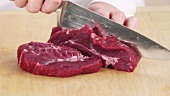 Cutting beef into thick slices
