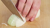 Slicing onions in half and chopping roughly