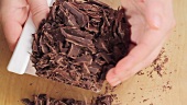 Placing chopped chocolate in a metal bowl