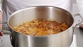 Beef goulash cooking in a saucepan