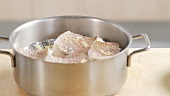 Steamed fish fillets in a saucepan