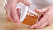 Shaking a jar of marmalade to remove air pockets