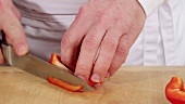 Cutting red pepper into strips