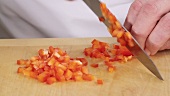 Finely chopping a red pepper
