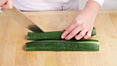 A cucumber being sliced