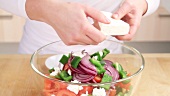Feta being added to salad
