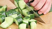 A cucumber being chopped
