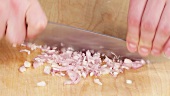 Shallots being finely chopped