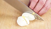 A hard boiled egg being chopped