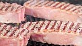 New York strip steaks being grilled