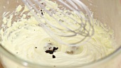 Vanilla seeds being stirred into butter