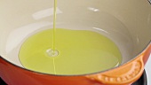 Oil being added to a saucepan