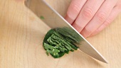 Mint leaves being finely sliced