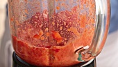 Strawberries being puréed in a blender