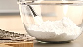 Icing sugar in a glass bowl