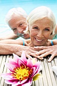 Germany, Senior couple in pool, close-up