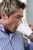 Young man drinking glas of milk