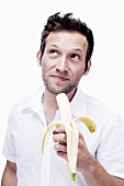 Young man eating a banana