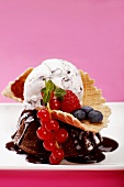 Scoops of Stracciatella and chocolate ice cream with wild berries, close-up