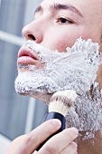 Man applying shaving foam