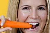 Woman eating bell pepper, close-up