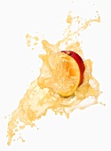 Half a mango with splashing mango juice