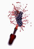 Red wine splashing out of bottle