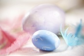Pastel-coloured Easter eggs and feathers