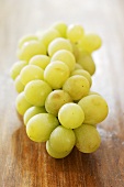 Green grapes on wooden table