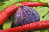 Fig, chillies and mangetout with drops of water (close-up)