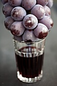 Glass of red wine and red grapes