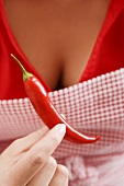 Woman holding red chilli