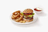 Hamburger with chips and fried onion rings