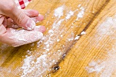 Dusting a work surface with flour