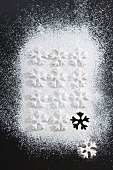 Christmas biscuits with icing sugar (overhead view)