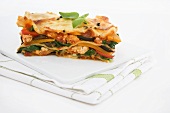Vegetable lasagne on chopping board