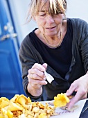 Woman cleaning chanterelles