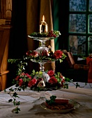 Christmas decoration on tiered stand with ivy and red roses